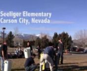 Physics instructors Tom Herring and Robert Collier from Western Nevada College doing a science demonstration at Seeliger Elementary. Nice sunny day in Carson City Nevada and you can see the snow on the mountains in the background. Tom and Robert used 2 liters of liquid nitrogen, a 55 gallon steel drum and 4000 ping pong balls. As the nitrogen changes from liquid to gas it expands causing the bottle to rupture. This minor explosion generates enough energy to propel most of the ping pong balls 50