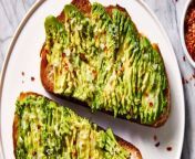 Olive oil toasted whole wheat sourdough bread is topped with ripe avocado, garlic, lemon juice, and red pepper flakes.