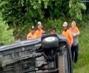 A group of strangers banded together to overturn a flipped car and rescue a woman trapped inside.&#60;br/&#62;&#60;br/&#62;A video filmed near exit 221 of the Interstate 40 in Hermitage, Tennessee, USA, shows people running towards the silver vehicle overturned in the side of the road. &#60;br/&#62;&#60;br/&#62;The group of 10 men and women successfully flipped the car over, revealing the airbags of the vehicle.&#60;br/&#62;&#60;br/&#62;Carolina Carlos, who filmed the video, said that the woman inside the vehicle was unharmed and that the group waited for officials to arrive. &#60;br/&#62;&#60;br/&#62;She said that she filmed the moment to highlight the kindness shown by the group of strangers.